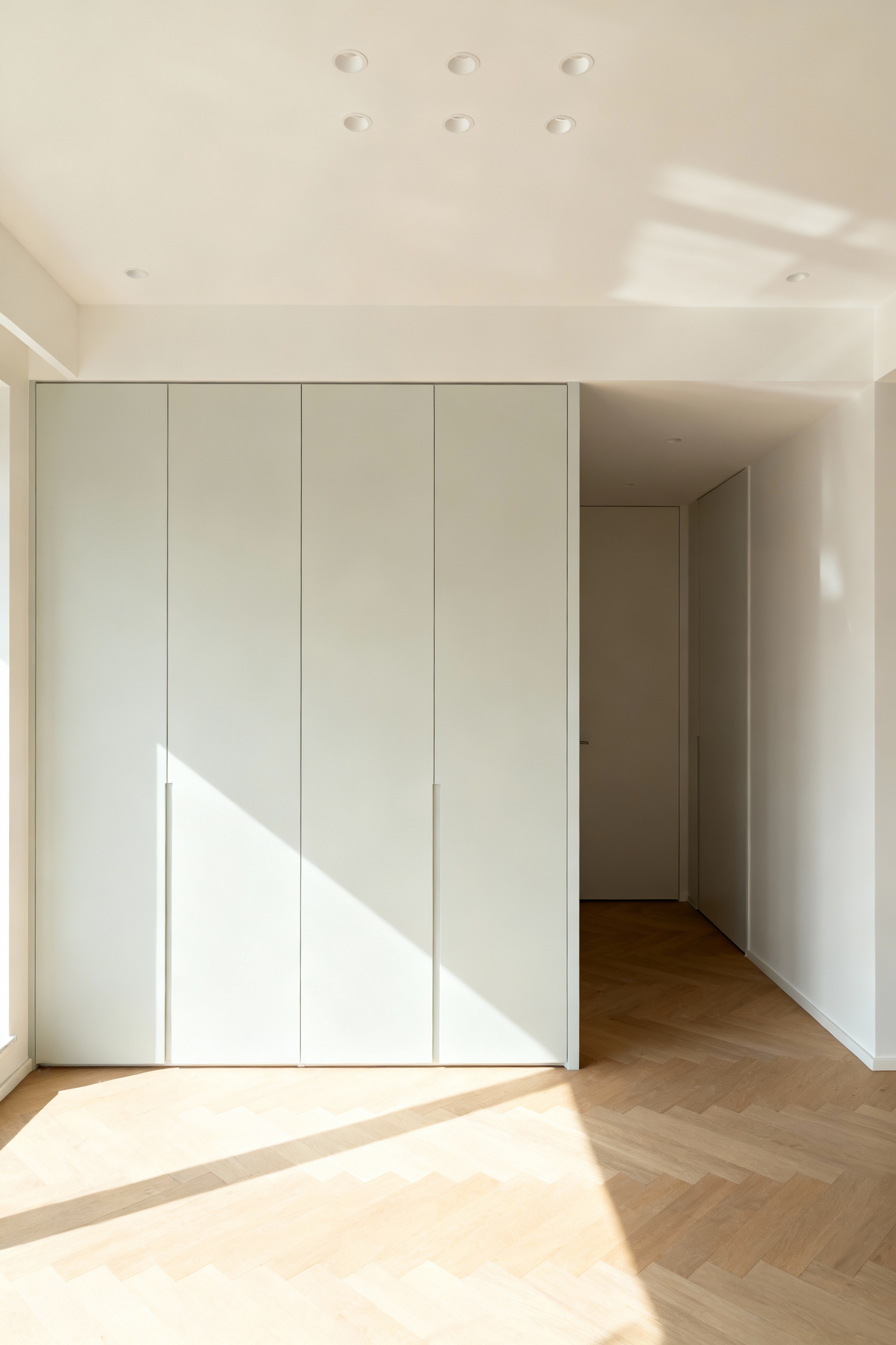 Compact Scandinavian kitchen with light-toned off-white cabinets, bright and airy, reflecting natural light for visual expansion, minimalist design.