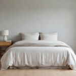 A photograph of a calm, balanced Scandinavian bedroom featuring light wood and cream linen textiles, illustrating the Lagom design philosophy of perfect equilibrium.